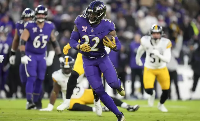 Baltimore Ravens running back Derrick Henry runs with the ball against the Pittsburgh Steelers during the first half of an NFL football game, Saturday, Dec. 21, 2024, in Baltimore. (AP Photo/Stephanie Scarbrough)