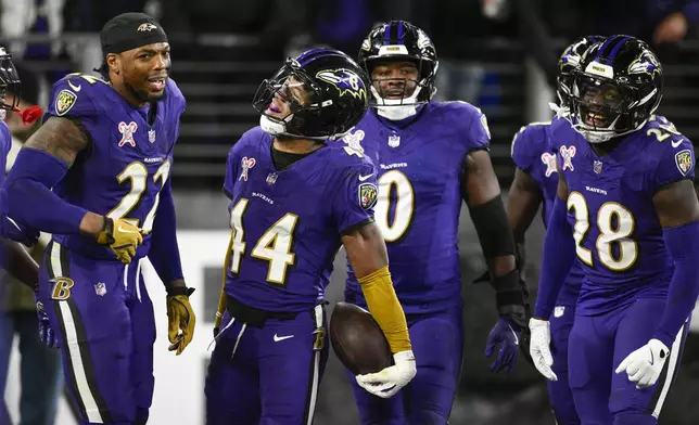 Baltimore Ravens cornerback Marlon Humphrey (44) celebrates his pick-6 interception score with teammates during the second half of an NFL football game against the Pittsburgh Steelers, Saturday, Dec. 21, 2024, in Baltimore. (AP Photo/Nick Wass)