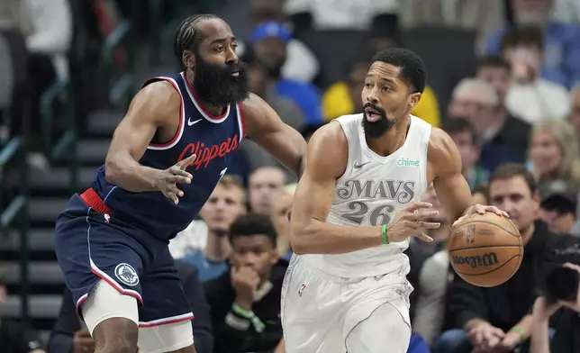 Los Angeles Clippers' James Harden defends as Dallas Mavericks guard Spencer Dinwiddie (26) looks to make a pass in the first half of an NBA basketball game in Dallas, Thursday, Dec. 19, 2024. (AP Photo/Tony Gutierrez)