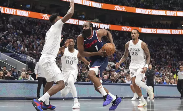 Los Angeles Clippers guard James Harden (1) drives to the basket as Dallas Mavericks' Olivier-Maxence Prosper, left, and P.J. Washington (25) defend in the first half of an NBA basketkbal lgame in Dallas, Thursday, Dec. 19, 2024. (AP Photo/Tony Gutierrez)