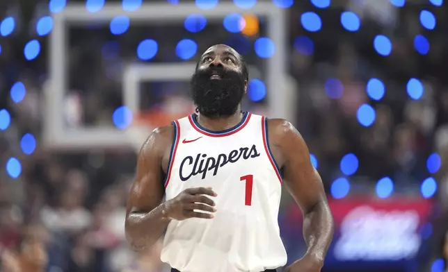 Los Angeles Clippers guard James Harden looks toward the scoreboard after making a three-point shot that put him at 2,998 points for three-point shots during the first half of an NBA basketball game against the Denver Nuggets, Sunday, Dec. 1, 2024, in Inglewood, Calif. (AP Photo/Mark J. Terrill)