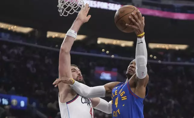 Denver Nuggets guard Russell Westbrook, right, shoots as Los Angeles Clippers center Ivica Zubac defends during the first half of an NBA basketball game, Sunday, Dec. 1, 2024, in Inglewood, Calif. (AP Photo/Mark J. Terrill)