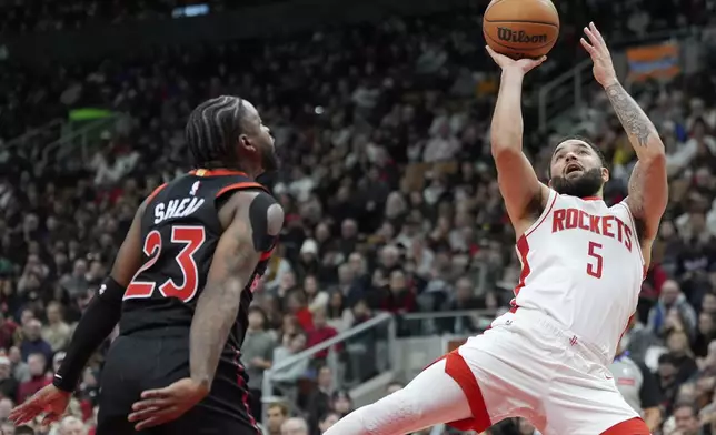 Houston Rockets guard Fred VanVleet (5) looks to shoot over Toronto Raptors guard Jamal Shead (23) during second-half NBA basketball game action in Toronto, Sunday, Dec. 22, 2024. (Frank Gunn/The Canadian Press via AP)