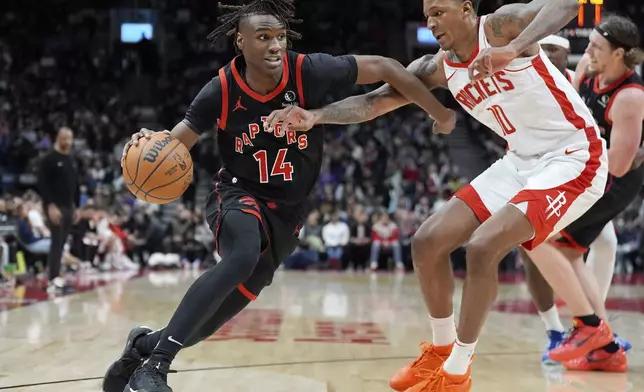 Houston Rockets forward Jabari Smith Jr. (10) fouls Toronto Raptors guard Ja'Kobe Walter (14) during second-half NBA basketball game action in Toronto, Sunday, Dec. 22, 2024. (Frank Gunn/The Canadian Press via AP)