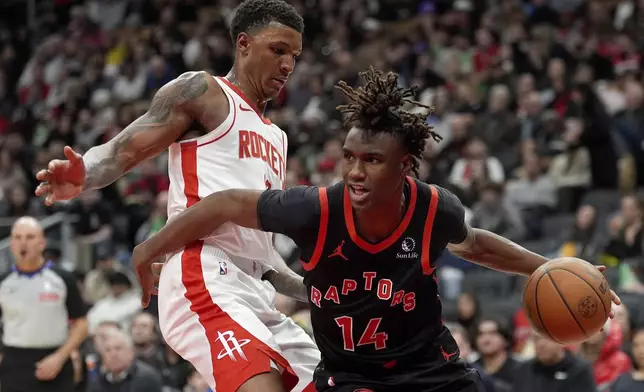 Toronto Raptors guard Ja'Kobe Walter (14) moves the ball around Houston Rockets forward Jabari Smith Jr., left, during second-half NBA basketball game action in Toronto, Sunday, Dec. 22, 2024. (Frank Gunn/The Canadian Press via AP)