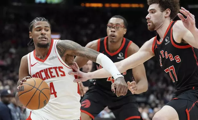 Toronto Raptors forward Jamison Battle (77) pressures Houston Rockets guard Jalen Green (4) during first-half NBA basketball game action in Toronto, Sunday, Dec. 22, 2024. (Frank Gunn/The Canadian Press via AP)