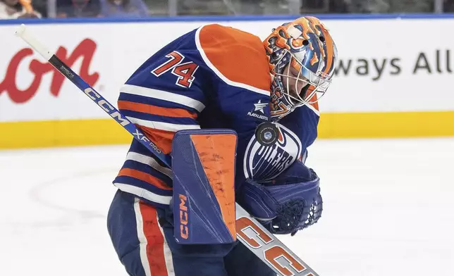 Edmonton Oilers goalie Stuart Skinner (74) makes a save against the Tampa Bay Lightning during the third period of an NHL hockey game, Tuesday, Dec. 10, 2024 in Edmonton, Alberta. (Jason Franson/The Canadian Press via AP)