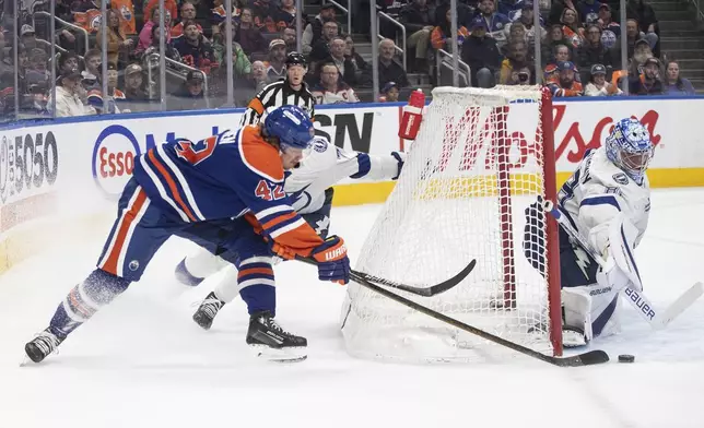 Tampa Bay Lightning goalie Andrei Vasilevskiy (88) makes a save on Edmonton Oilers' Kasperi Kapanen (42) during the second period of an NHL hockey game, Tuesday, Dec. 10, 2024 in Edmonton, Alberta. (Jason Franson/The Canadian Press via AP)