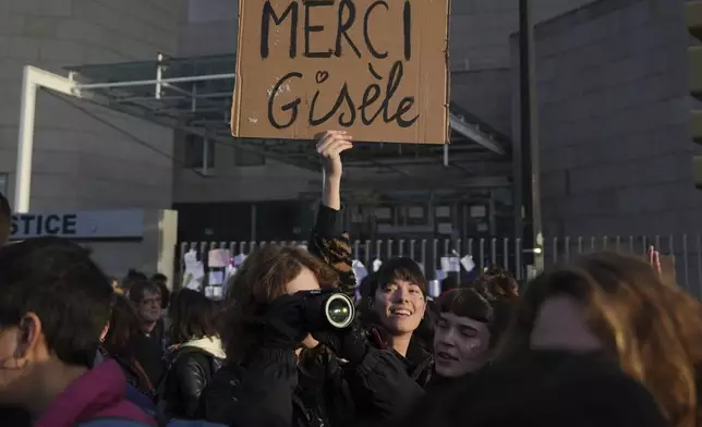 FILE - A woman holds a placard that reads, "Thank you Gisele," outside the Palace of Justice during a women's rights demonstration, Dec. 14, 2024, in Avignon, southern France, where dozens of men are on trial in Avignon, accused of raping Gisèle Pelicot while she was drugged and rendered unconscious by her husband. (AP Photo/Aurelien Morissard, File)