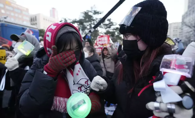 A participant weeps after hearing the news that South Korea's parliament voted to impeach President Yoon Suk Yeol outside the National Assembly in Seoul, South Korea, Saturday, Dec. 14, 2024. (AP Photo/Lee Jin-man)