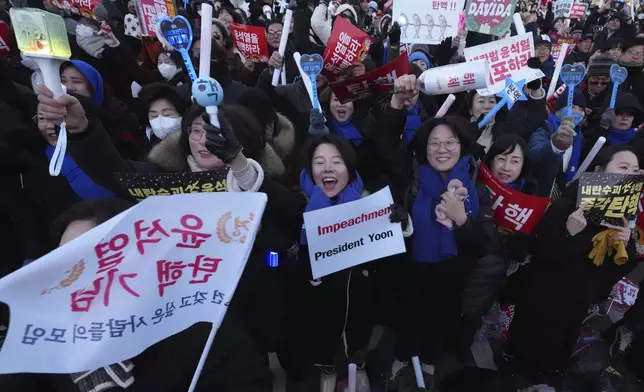 Participants react after hearing the news that South Korea's parliament voted to impeach President Yoon Suk Yeol outside the National Assembly in Seoul, South Korea, Saturday, Dec. 14, 2024. (AP Photo/Lee Jin-man)