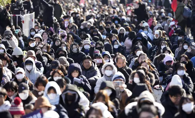 People wait before a rally to demand South Korean President Yoon Suk Yeol's impeachment outside the National Assembly in Seoul, South Korea, Saturday, Dec. 14, 2024. (AP Photo/Lee Jin-man)