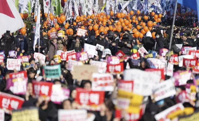 People march for a rally to demand South Korean President Yoon Suk Yeol's impeachment outside the National Assembly in Seoul, South Korea, Saturday, Dec. 14, 2024. (AP Photo/Lee Jin-man)