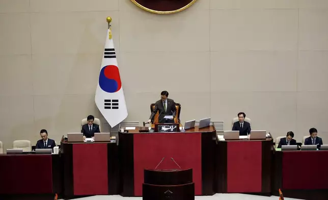 South Korean National Assembly Speaker Woo Won-shik, center, bangs with announcing the president impeachment after the impeachment vote of President Yoon Suk Yeol at the National Assembly in Seoul Saturday, Dec. 14, 2024. (Woohae Cho/Pool Photo via AP)