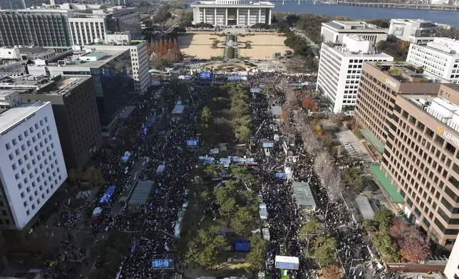 Participants gather during a rally to demand South Korean President Yoon Suk Yeol's impeachment outside the National Assembly in Seoul, South Korea, Saturday, Dec. 14, 2024. (Kim Do-hoon/Yonhap via AP)