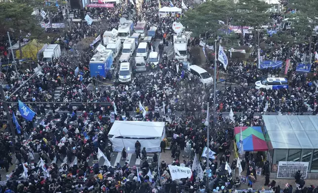 Participants gather during a rally to demand South Korean President Yoon Suk Yeol's impeachment outside the National Assembly in Seoul, South Korea, Saturday, Dec. 14, 2024. (AP Photo/Ahn Young-joon)