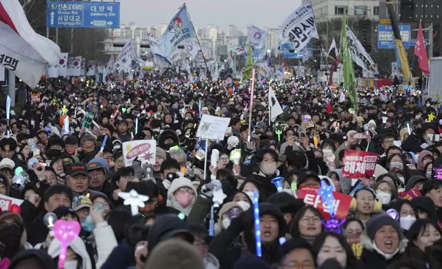 Participants celebrate after hearing the news that South Korea's parliament voted to impeach President Yoon Suk Yeol outside the National Assembly in Seoul, South Korea, Saturday, Dec. 14, 2024. (AP Photo/Lee Jin-man)