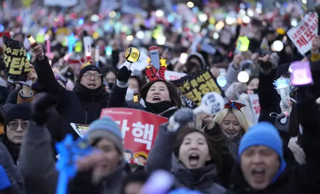 Participants celebrate after hearing the news that South Korea's parliament voted to impeach President Yoon Suk Yeol outside the National Assembly in Seoul, South Korea, Saturday, Dec. 14, 2024. (AP Photo/Ahn Young-joon)
