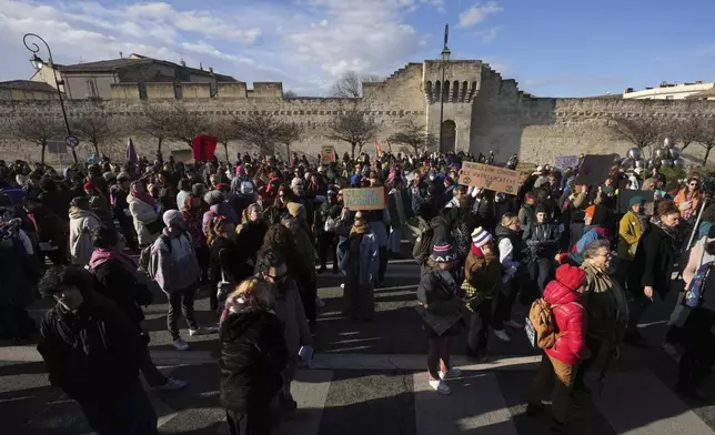 Activists gather during a women's rights demonstration, Saturday, Dec. 14, 2024 in Avignon, southern France, where the trial of dozens of men accused of raping Gisèle Pelicot while she was drugged and rendered unconscious by her husband is taking place. (AP Photo/Aurelien Morissard)