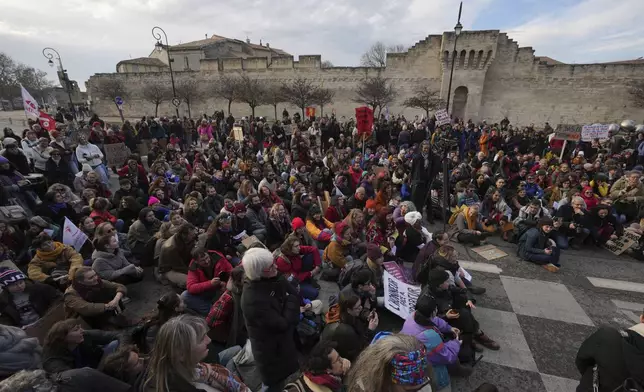 Activists gather during a women's rights demonstration, Saturday, Dec. 14, 2024 in Avignon, southern France, where the trial of dozens of men accused of raping Gisèle Pelicot while she was drugged and rendered unconscious by her husband is taking place. (AP Photo/Aurelien Morissard)