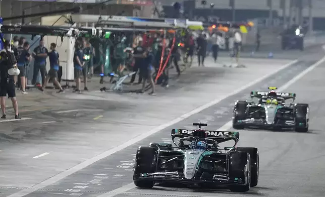 Mercedes driver George Russell of Britain, front, and Mercedes driver Lewis Hamilton of Britain leave the pit lane during the qualifying for the Formula One Abu Dhabi Grand Prix at the Yas Marina Circuit in Abu Dhabi, UAE, Saturday, Dec. 7, 2024. (AP Photo/Altaf Qadri)