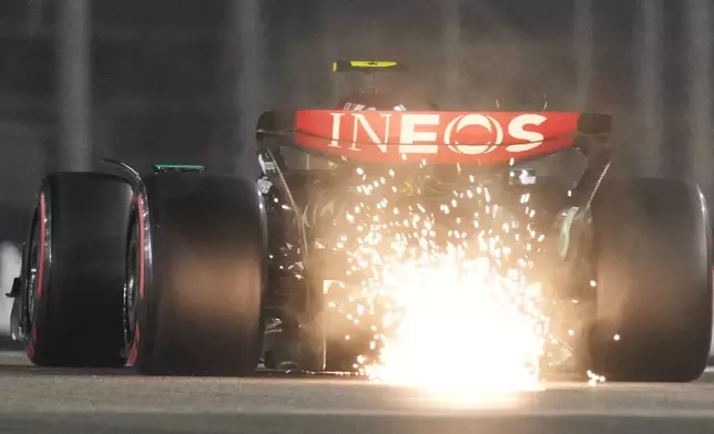 Mercedes driver Lewis Hamilton of Britain creates sparks as his car touches the track during the qualifying for the Formula One Abu Dhabi Grand Prix at the Yas Marina Circuit in Abu Dhabi, UAE, Saturday, Dec. 7, 2024. (AP Photo/Altaf Qadri)