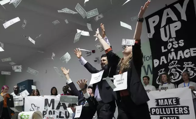 FILE - Activists participate in a demonstration for climate finance at the COP29 U.N. Climate Summit, Nov. 21, 2024, in Baku, Azerbaijan. (AP Photo/Sergei Grits, File)