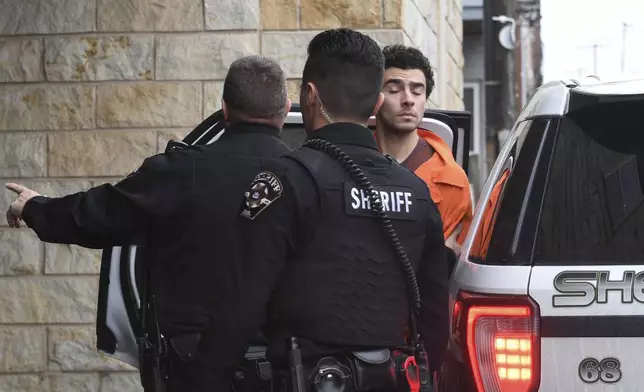 Luigi Nicholas Mangione is escorted into Blair County Courthouse, Tuesday, Dec. 10, 2024, in Hollidaysburg, Pa. (AP Photo/Gary M. Baranec)