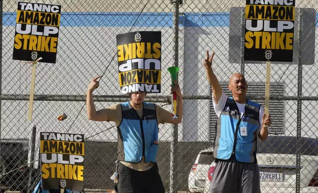 Amazon workers strike outside the gates of an Amazon Fulfillment Center as Teamsters seek labor contract nationwide Friday, Dec. 20, 2024, in City of Industry, Calif. (AP Photo/Damian Dovarganes)