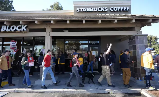 Starbucks baristas and other workers start a five-day strike to protest a lack of progress in contract negotiations with the company Friday, Dec. 20, 2024, in Burbank, Calif. (AP Photo/Damian Dovarganes)