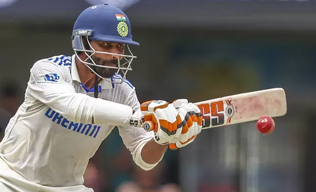 India's Ravindra Jadeja plays a shot during play on day four of the third cricket test between India and Australia at the Gabba in Brisbane, Australia, Tuesday, Dec. 17, 2024. (AP Photo/Pat Hoelscher)