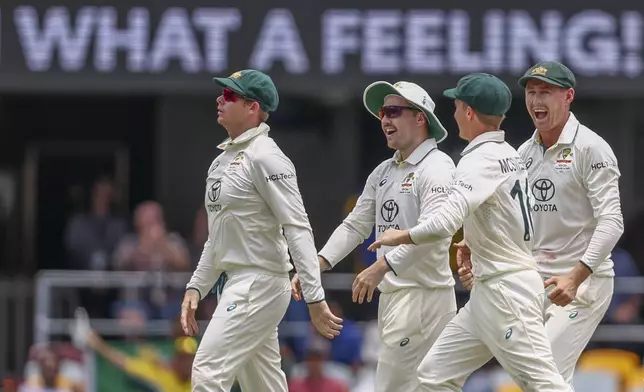 Australia's Steve Smith, left, celebrates with teammates after the dismissal of India's KL Rahul during play on day four of the third cricket test between India and Australia at the Gabba in Brisbane, Australia, Tuesday, Dec. 17, 2024. (AP Photo/Pat Hoelscher)