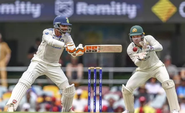 India's Ravindra Jadeja plays a shot during play on day four of the third cricket test between India and Australia at the Gabba in Brisbane, Australia, Tuesday, Dec. 17, 2024. (AP Photo/Pat Hoelscher)