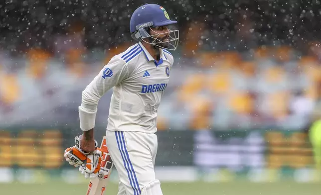 India's Ravindra Jadeja leaves the field as it rains during play on day four of the third cricket test between India and Australia at the Gabba in Brisbane, Australia, Tuesday, Dec. 17, 2024. (AP Photo/Pat Hoelscher)