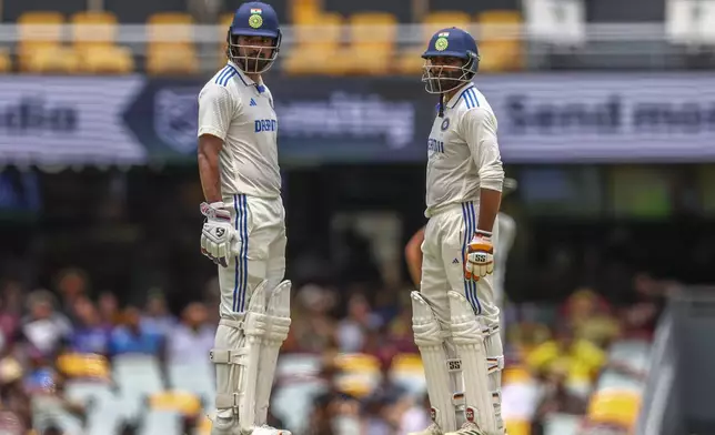 India's KL Rahul, left, and his batting partner looks on during play on day four of the third cricket test between India and Australia at the Gabba in Brisbane, Australia, Tuesday, Dec. 17, 2024. (AP Photo/Pat Hoelscher)