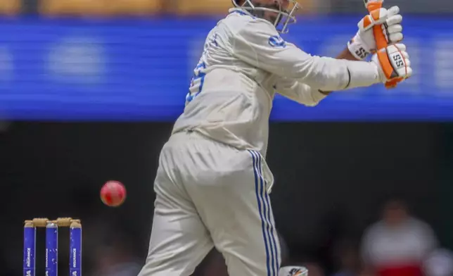 India's Ravindra Jadeja watches the ball after playing a shot during play on day four of the third cricket test between India and Australia at the Gabba in Brisbane, Australia, Tuesday, Dec. 17, 2024. (AP Photo/Pat Hoelscher)