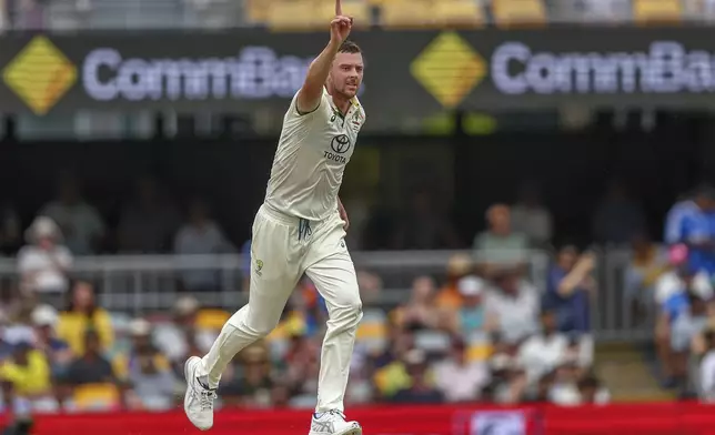 Australia's Josh Hazlewood celebrates the wicket of India's Virat Kohli during play on day three of the third cricket test between India and Australia at the Gabba in Brisbane, Australia, Monday, Dec. 16, 2024. (AP Photo/Pat Hoelscher)