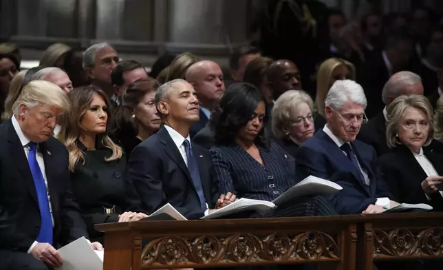 FILE - From left, President Donald Trump, first lady Melania Trump, former President Barack Obama, Michelle Obama, former President Bill Clinton and former Secretary of State Hillary Clinton listen during a State Funeral at the National Cathedral, Dec. 5, 2018, in Washington, for former President George H.W. Bush. (AP Photo/Alex Brandon, Pool, File)