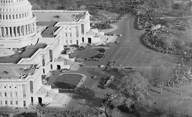 FILE - This is an aerial view of the Capitol as thousands and thousands of people line up in freezing weather to file past the casket of John F. Kennedy in the rotunda where his body lies in state, Nov. 25, 1963. (AP Photo/Bob Schutz, File)