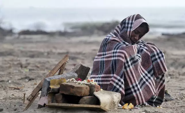 HOLD- Rani Amma, 50, grieves for her family who died in the Dec. 26 tsunami, as she sits near a small temple she made at the spot where her home once stood, at Nagappattinam, in the southern Indian state of Tamil Nadu, Wednesday, Jan. 12, 2005. Amma lost seven family members which include four granddaughters, one son, one daughter and one son-in-law. (AP Photo/Gautam Singh)