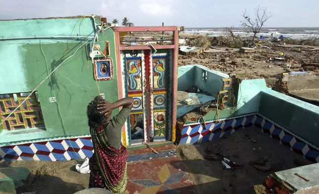 Paliyamma grieves on returning to her damaged house at a fishermen's colony hit by tsunami, in Nagappattinam, in the southern Indian state of Tamil Nadu, Friday, Dec. 31, 2004. Paliyamma lost seven members of her family. (AP Photo/Gurinder Osan, File)