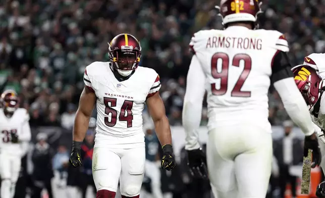 Washington Commanders linebacker Bobby Wagner (54) and Washington Commanders defensive end Dorance Armstrong (92) celebrate after a sack during an NFL football game against the Philadelphia Eagles, Nov. 14, 2024, in Philadelphia, PA. (AP Photo/Peter Joneleit)