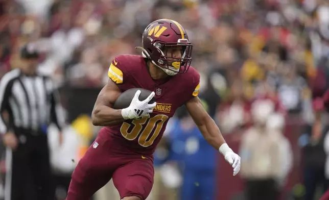 Washington Commanders running back Austin Ekeler rushes for a 1-yard rushing touchdown during the first half of an NFL football game against the Pittsburgh Steelers, Sunday, Nov. 10, 2024, in Landover, Md. (AP Photo/Stephanie Scarbrough)