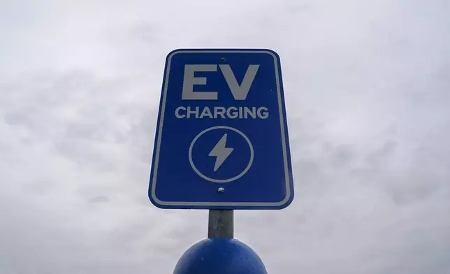 FILE - A sign is displayed at an electric vehicle charging station, March 8, 2024, in London, Ohio. (AP Photo/Joshua A. Bickel, File)