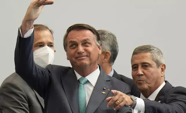 FILE - Brazilian President Jair Bolsonaro, left, and Defense Minister Walter Braga Netto attend a ceremony honoring military athletes who participated in the Tokyo 2020 Olympic Games at the military's Admiral Adalberto Nunes Physical Education Center in Rio de Janeiro, Sept. 1, 2021. (AP Photo/Silvia Izquierdo, File)