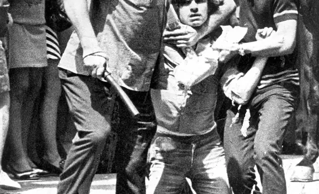 FILE - Unidentified men detain a student during a protest in Sao Paulo, Oct. 9, 1968. (AP Photo/Agencia Estado, File)