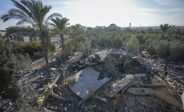 Palestinians look at home destroyed by an Israeli strike late Saturday in Deir al-Balah Sunday, Dec. 22, 2024. At least eight people were killed according to the hospital which received the bodies.(AP Photo/Abdel Kareem Hana)