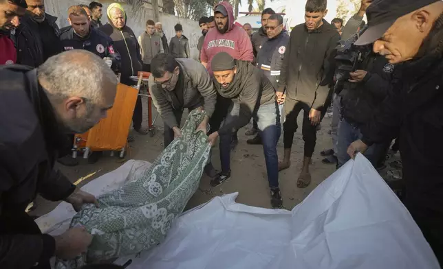 Bodies of victims of an Israeli strike on a home in Deir al-Balah late Saturday are prepared for the funeral outside the Al-Aqsa Martyrs Hospital in Deir al-Balah Sunday, Dec. 22, 2024. At least eight people were killed according to the hospital which received the bodies.(AP Photo/Abdel Kareem Hana)