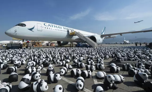 Part of 2500 panda sculptures are displayed at the Hong Kong International Airport during a welcome ceremony of the panda-themed exhibition "Panda Go!" in Hong Kong, Monday, Dec. 2, 2024. (AP Photo/Chan Long Hei)