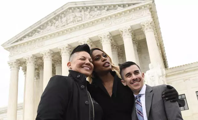 FILE - Sara Ramirez, from left, Laverne Cox and Chase Strangio, an attorney with the American Civil Liberties Union, pose for a photo outside the Supreme Court in Washington, Oct. 8, 2019. (AP Photo/Susan Walsh, File)